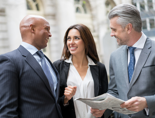 Group of business people reading the news and looking very happy